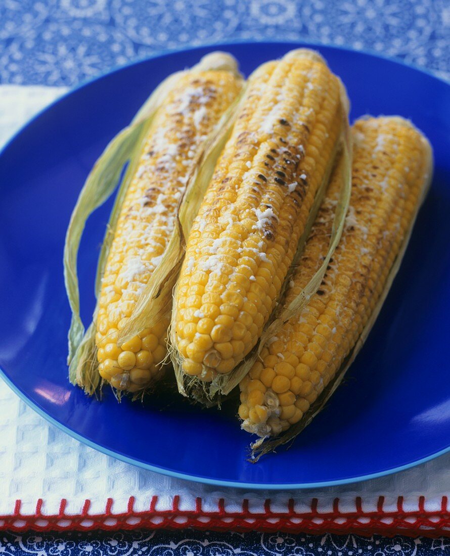 Three grilled corn cobs