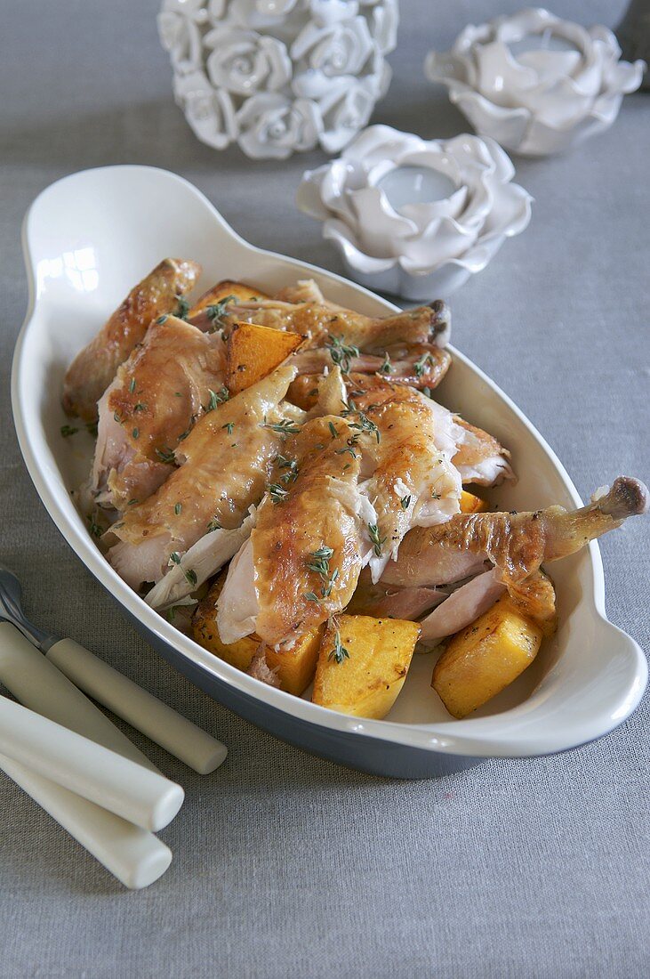 Pieces of roast chicken with potatoes and garlic