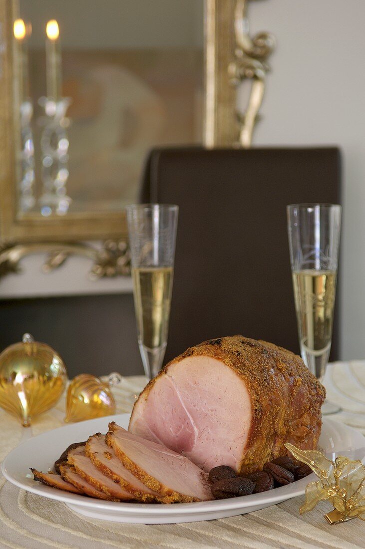 Roast ham with apricots on Christmas table