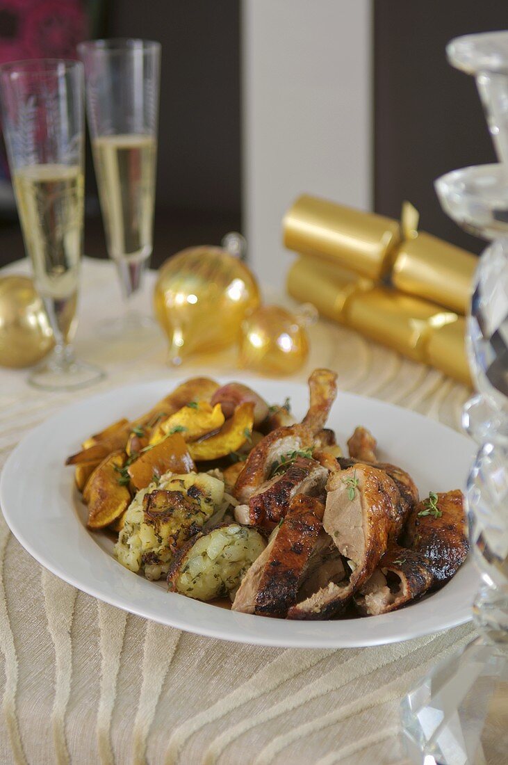 Pieces of Christmas goose with stuffing & root vegetables