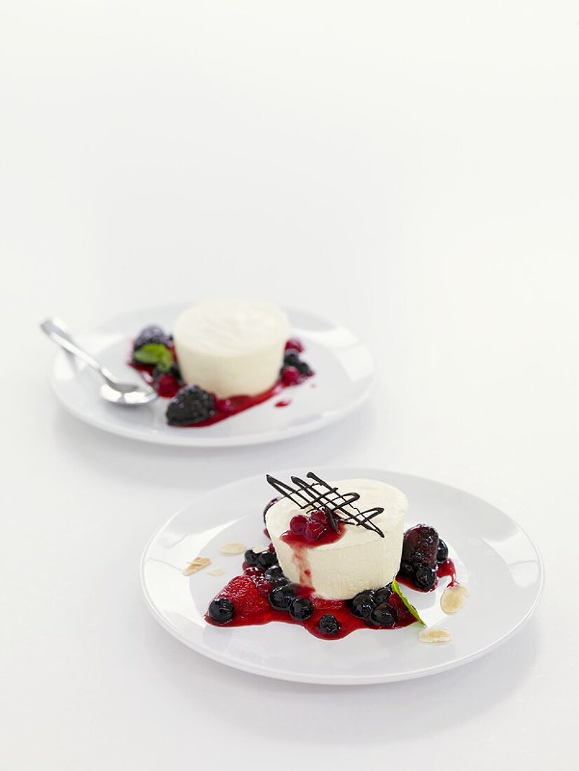 Two yoghurt parfaits with berry sauce