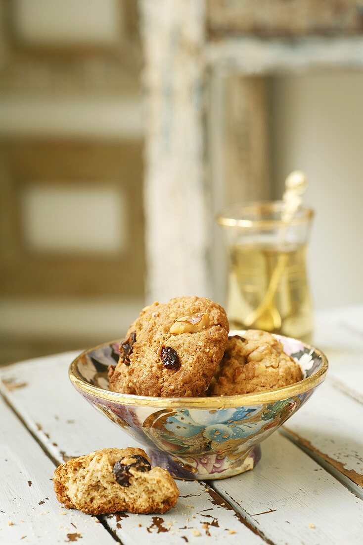 Oat biscuits with nuts and raisins in a small bowl