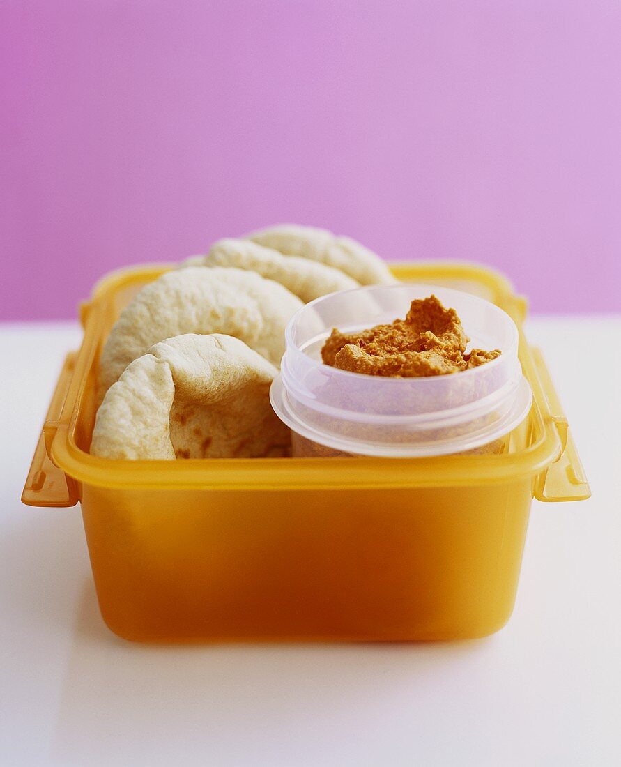 Pita bread with hummus in a plastic box