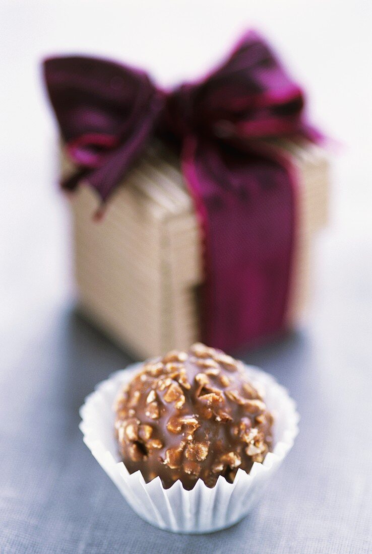 Nut chocolate in paper case with small gift