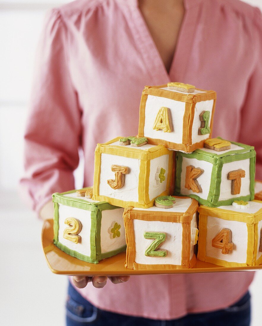 Cubes of cake decorated with letters and numbers (building bricks)