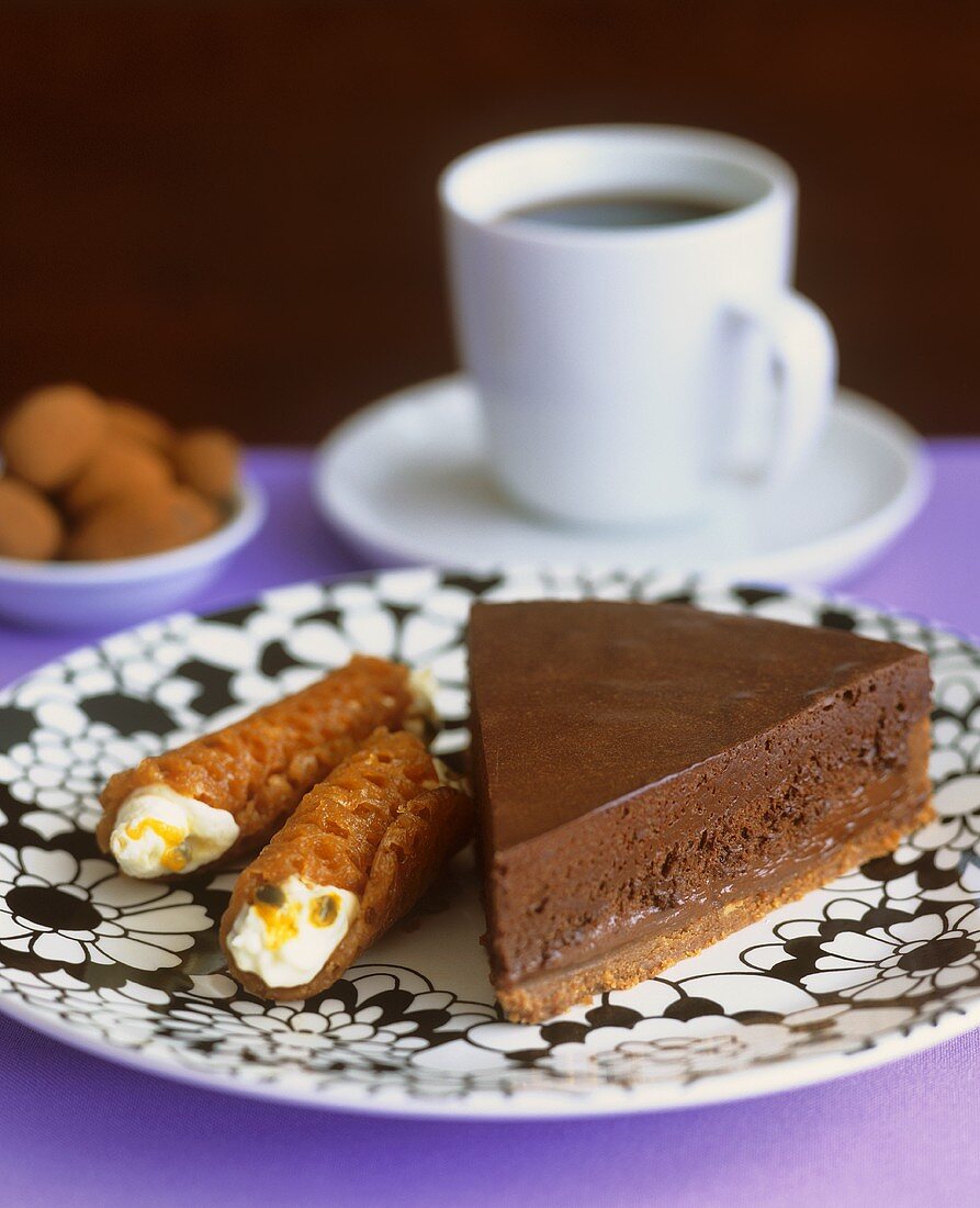 Piece of chocolate tart and brandy snaps with passion fruit filling