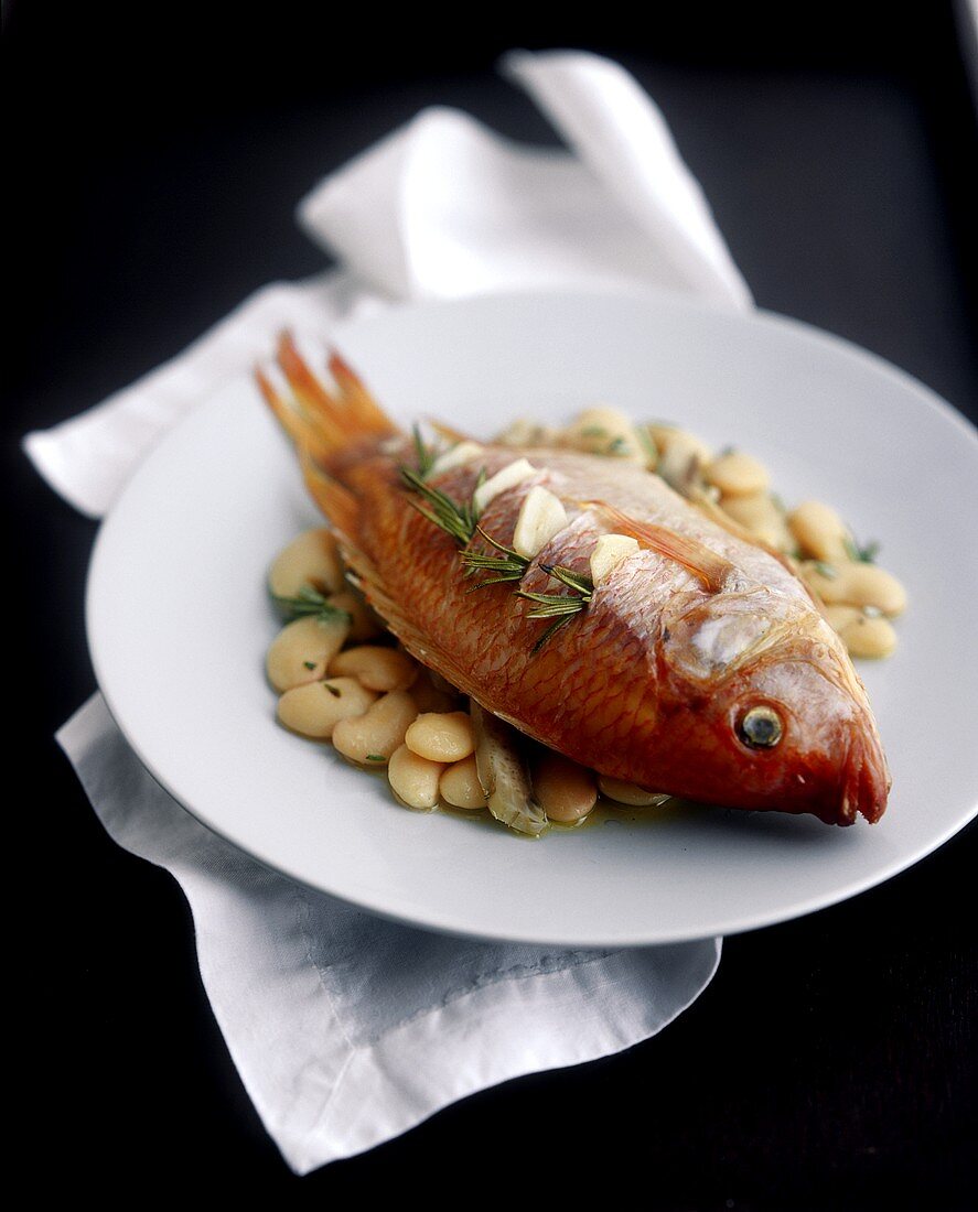 Red Snapper Stuffed with Garlic on a Bed of White Beans