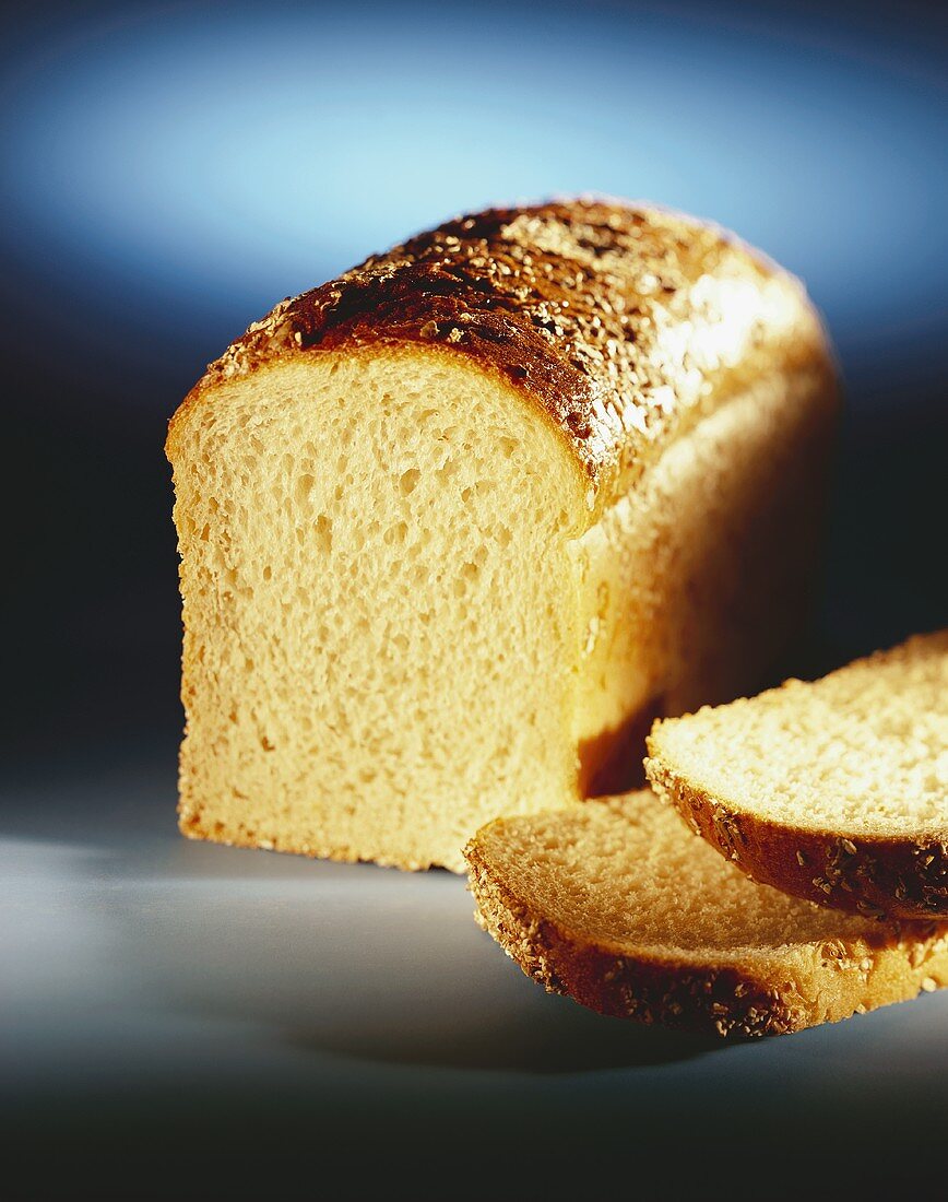 A Loaf of White Bread Partially Sliced