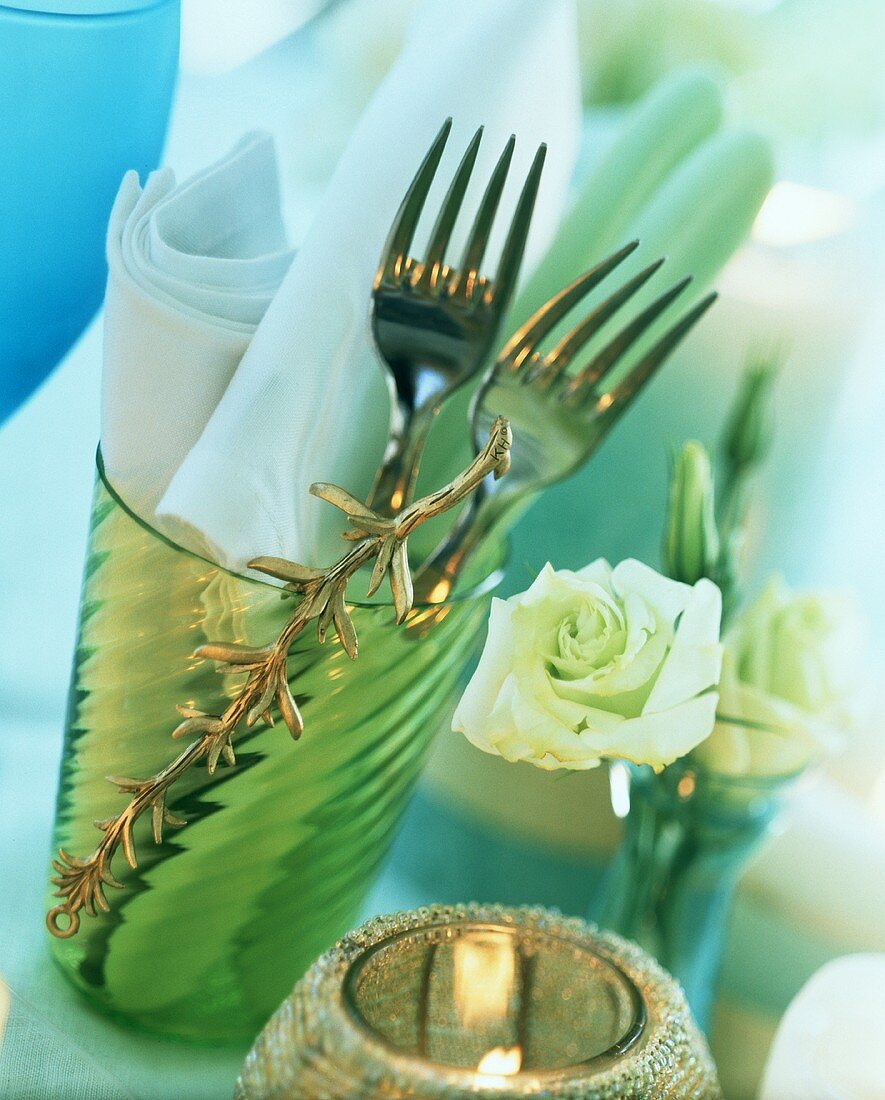 Table setting for two: forks and napkins in glass