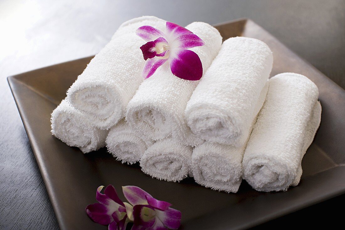 Rolled towels and orchid flowers