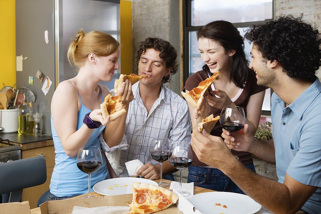 Friends sharing pizza at home