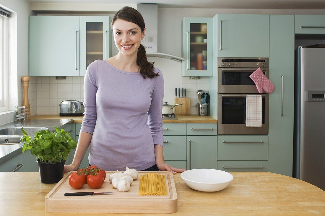 A woman with ingredients for pasta