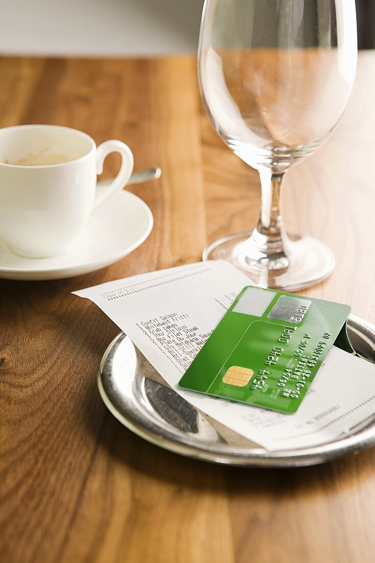 A bill and a credit card on a table