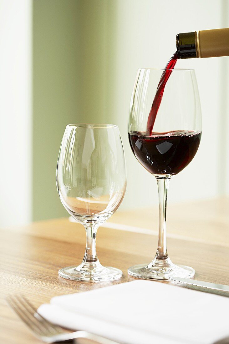 Red wine being poured into a wine glass