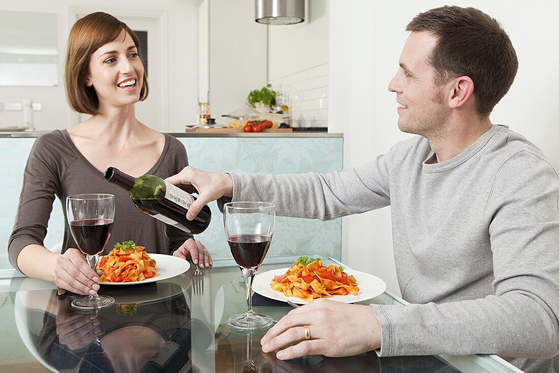 A couple having meal with wine