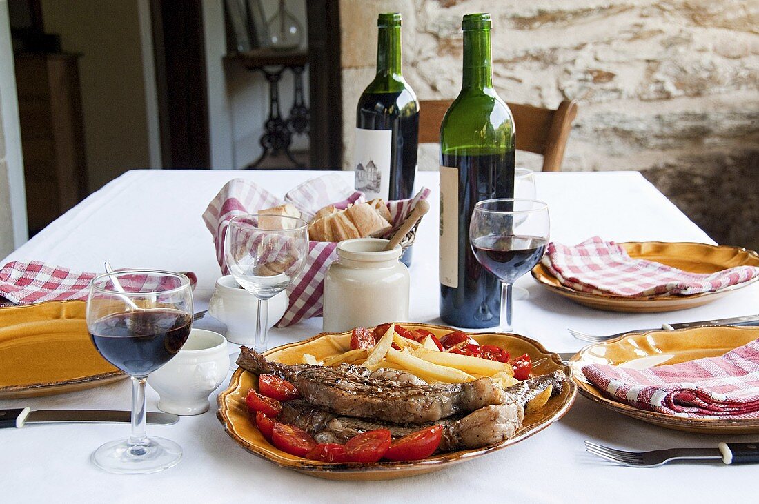 Steak and chips with wine