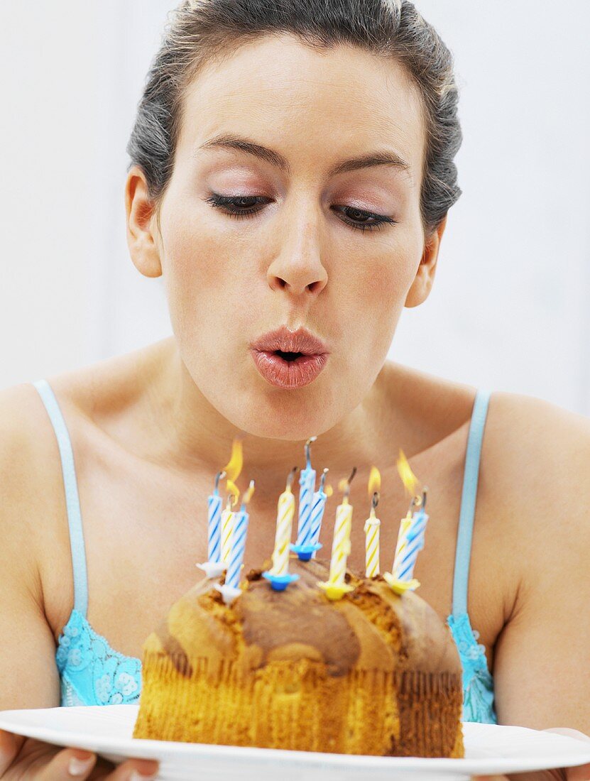 A woman blowing out birthday candles
