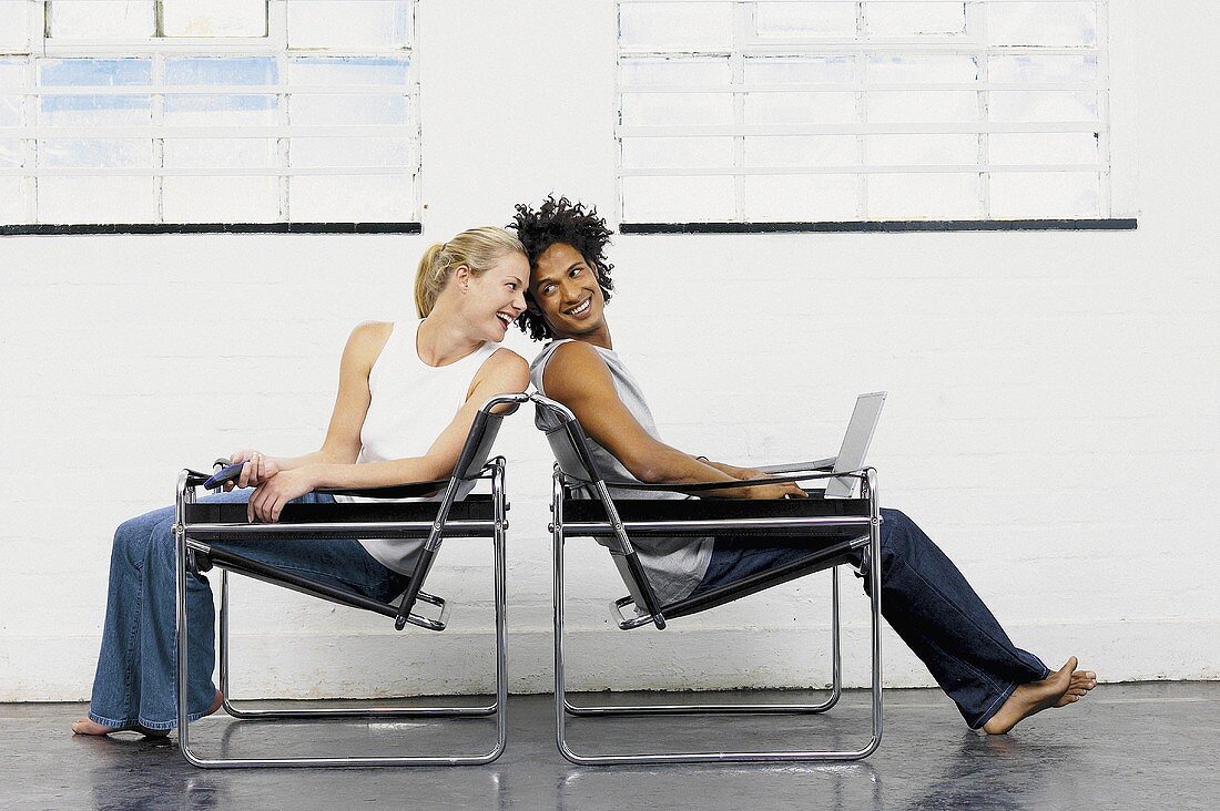 Couple playing on chairs