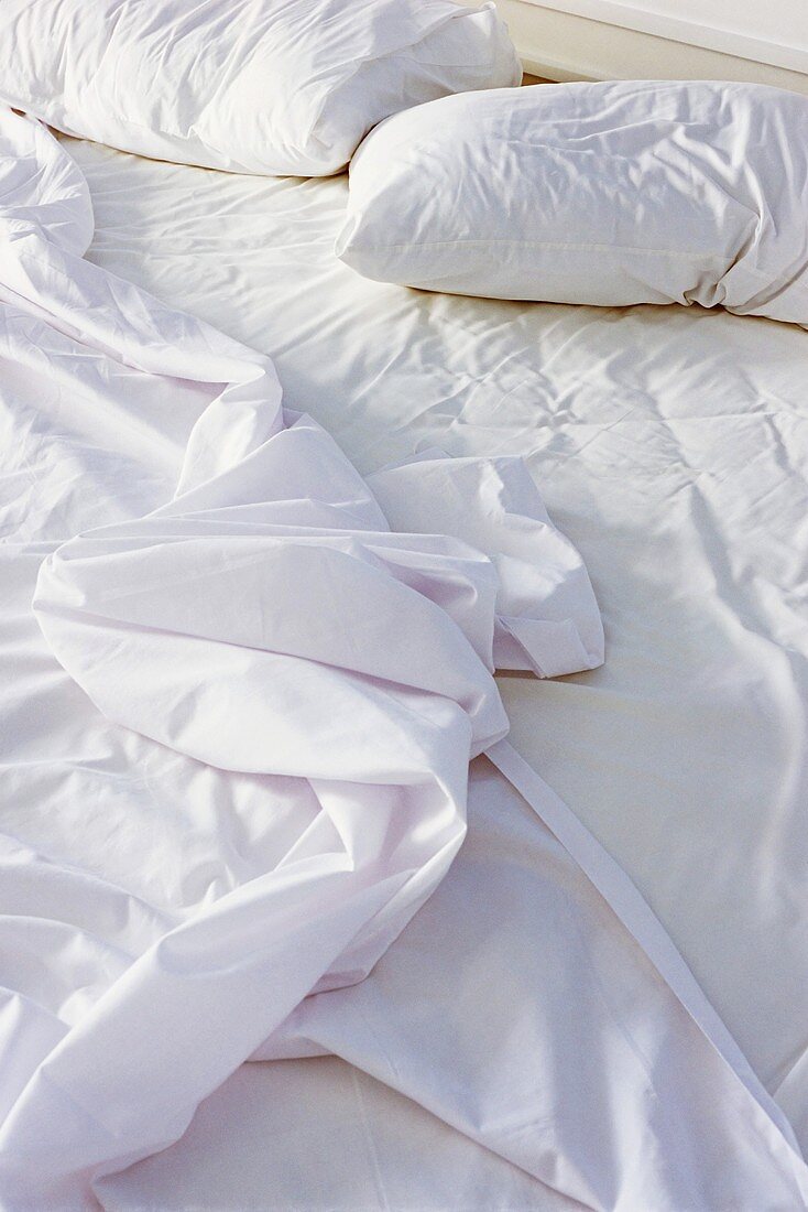 Crumpled sheets on bed