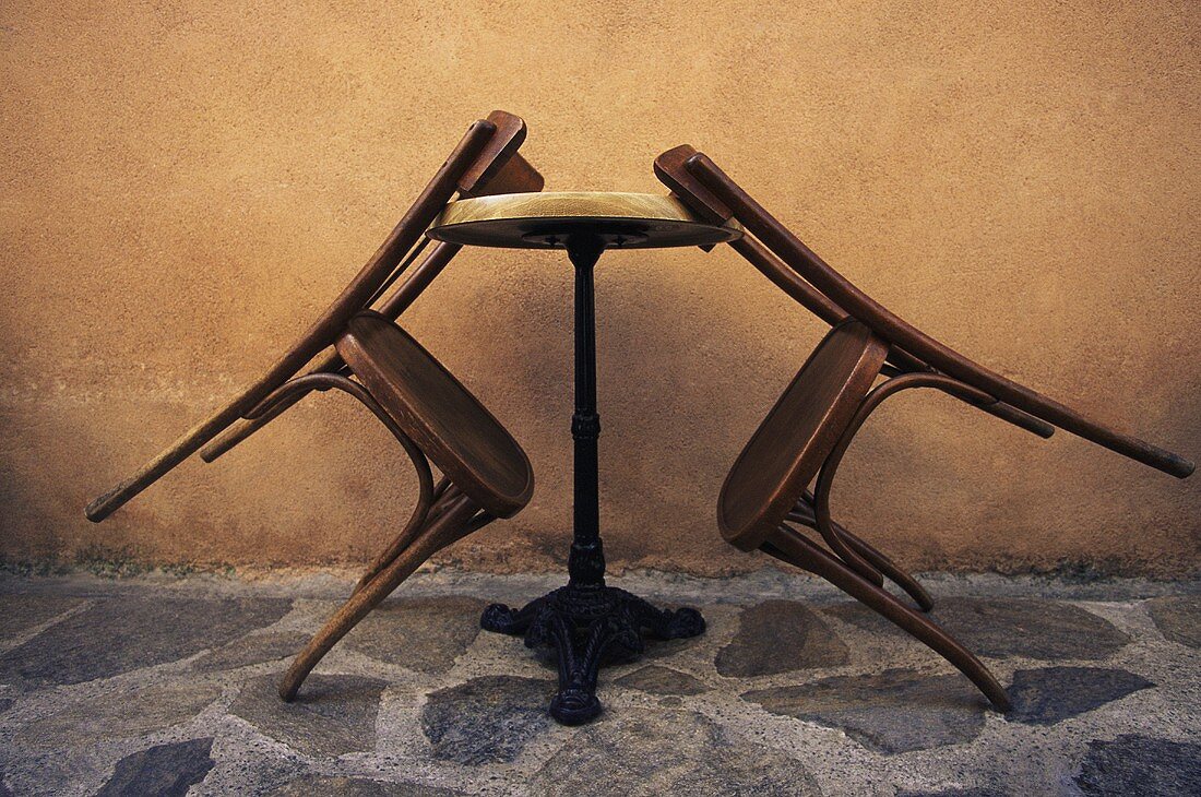 Wooden chairs leaning against a table