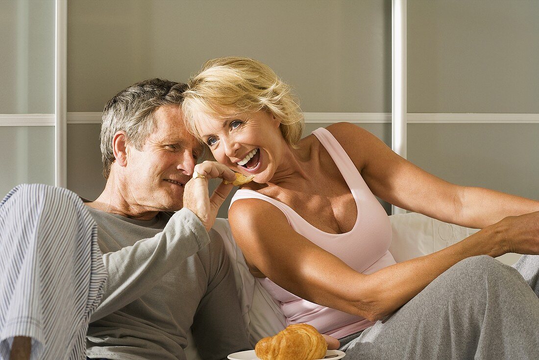 A couple sharing a croissant