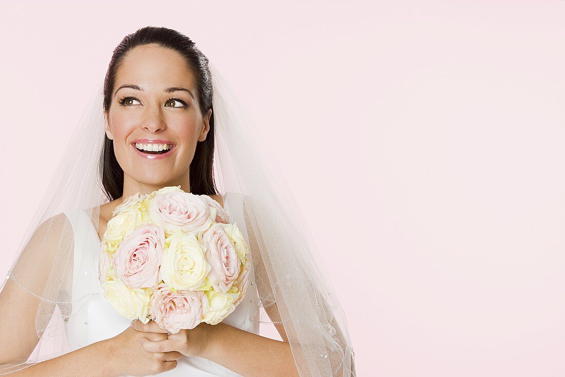 Smiling bride holding a bouquet
