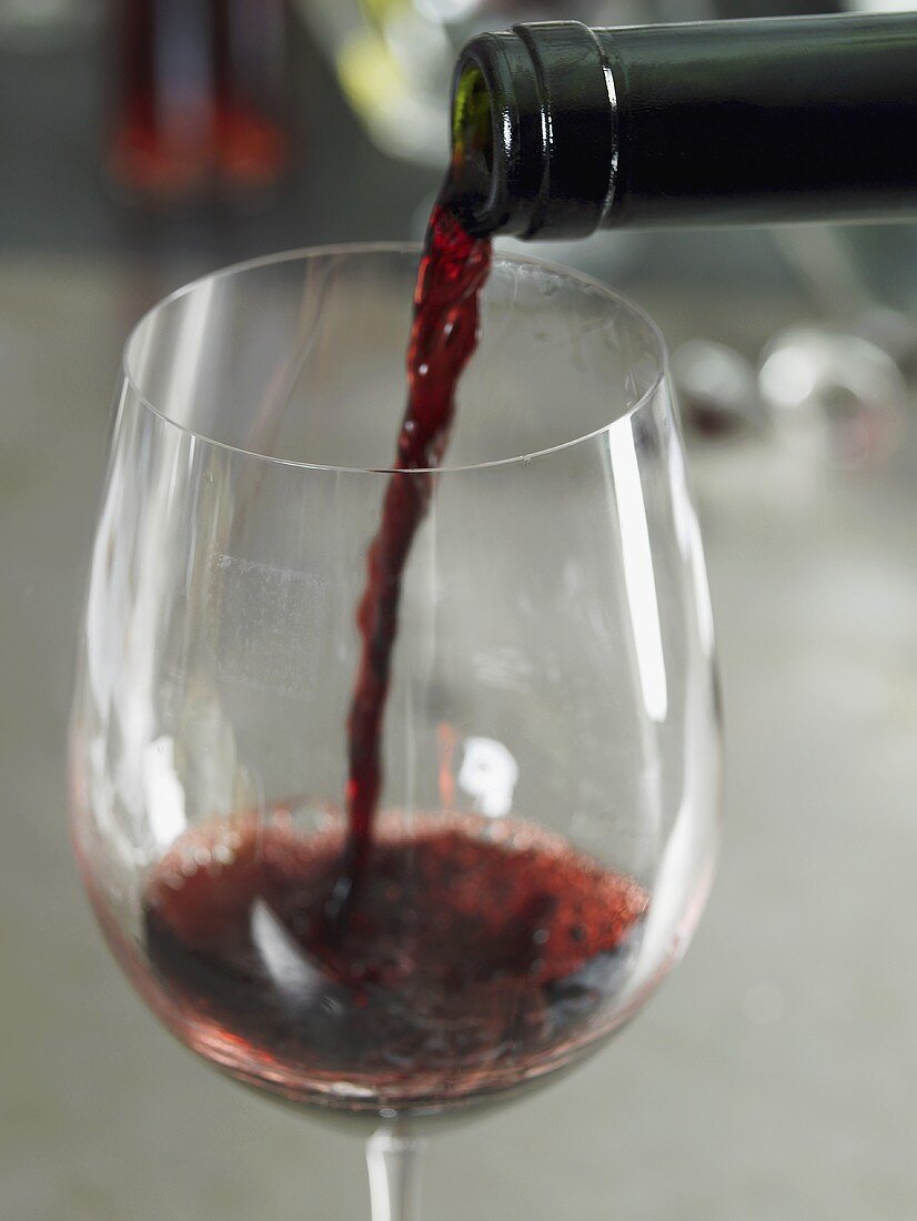 Red wine being poured into a glass