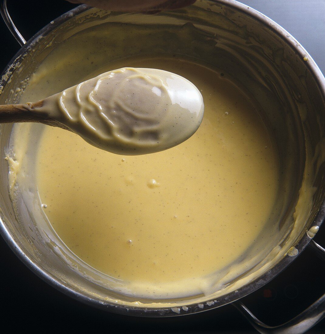Cooking custard until it coats the back of a spoon