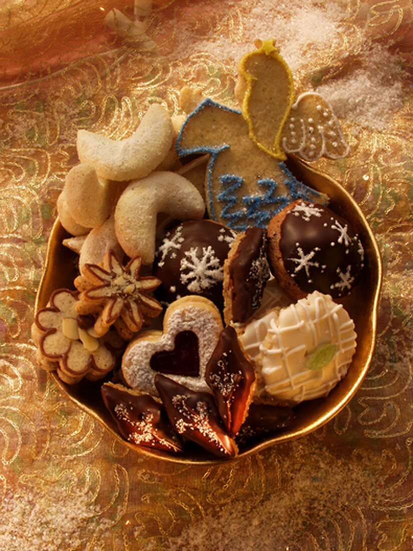 Assorted Christmas biscuits in golden bowl