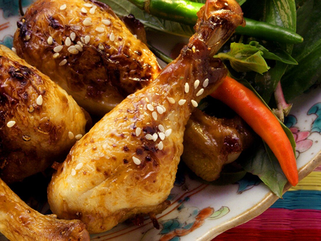 Asian chicken legs with sesame and chili peppers