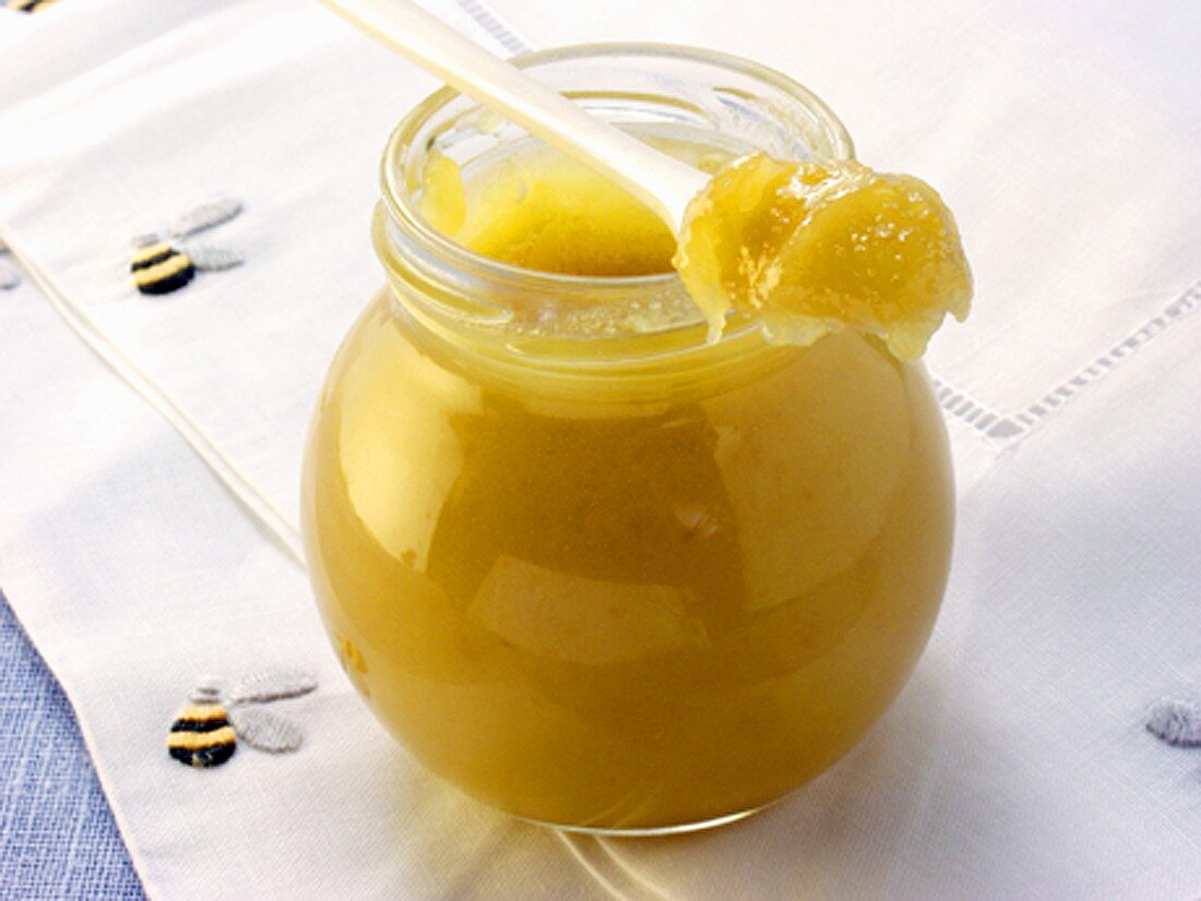 Blossom honey in jar and on spoon