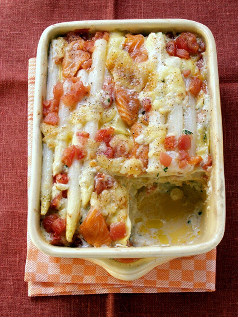 Asparagus bake with salmon and tomatoes in baking dish