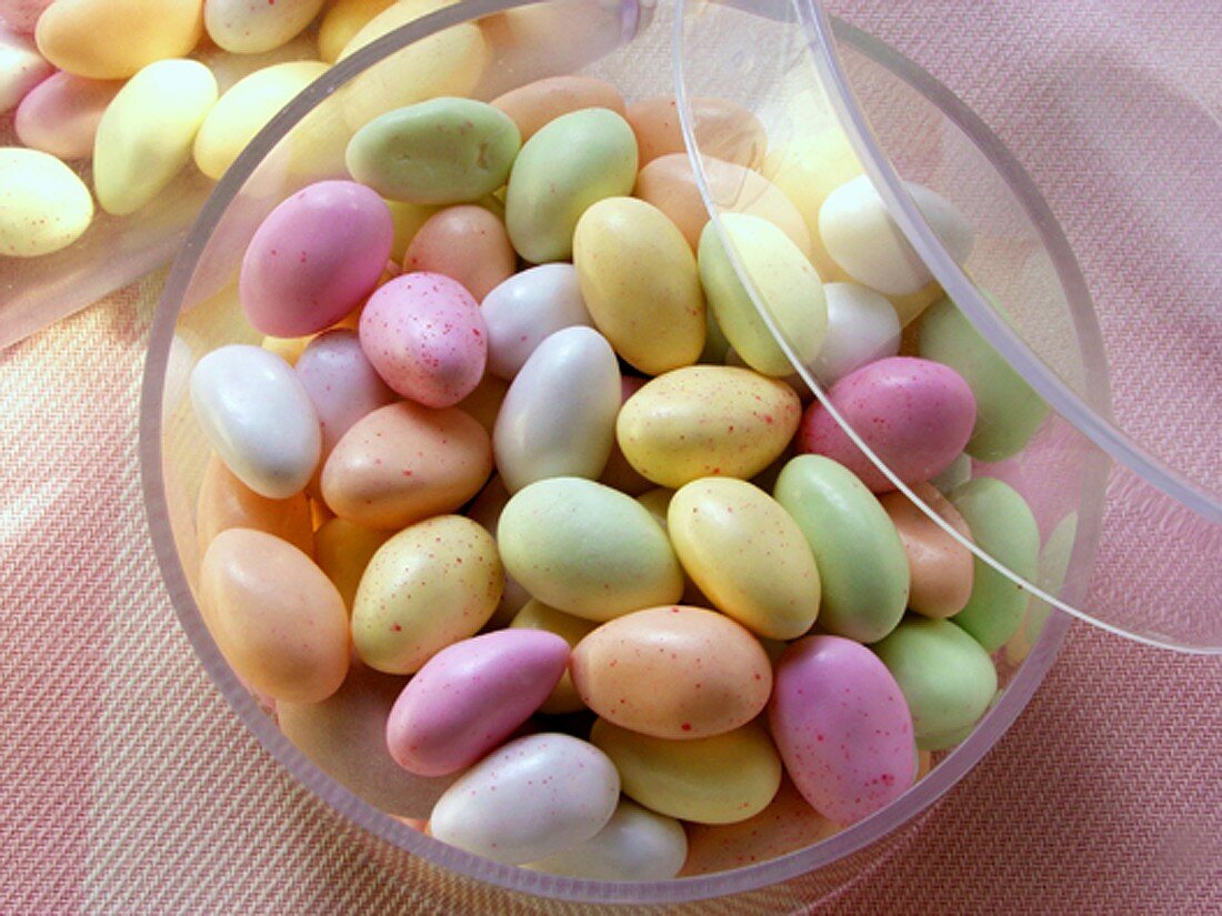 Pastel-coloured sugar eggs (jelly beans) in acrylic box