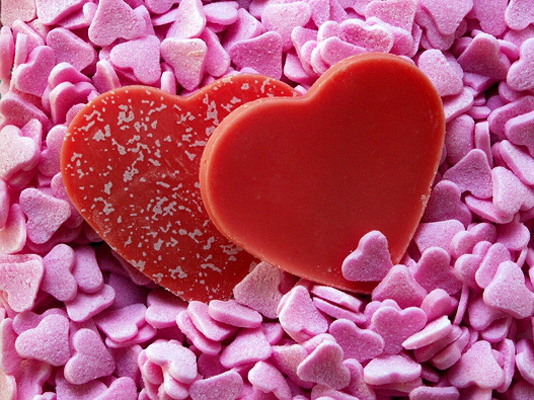 Red chocolate hearts on pink sugar hearts