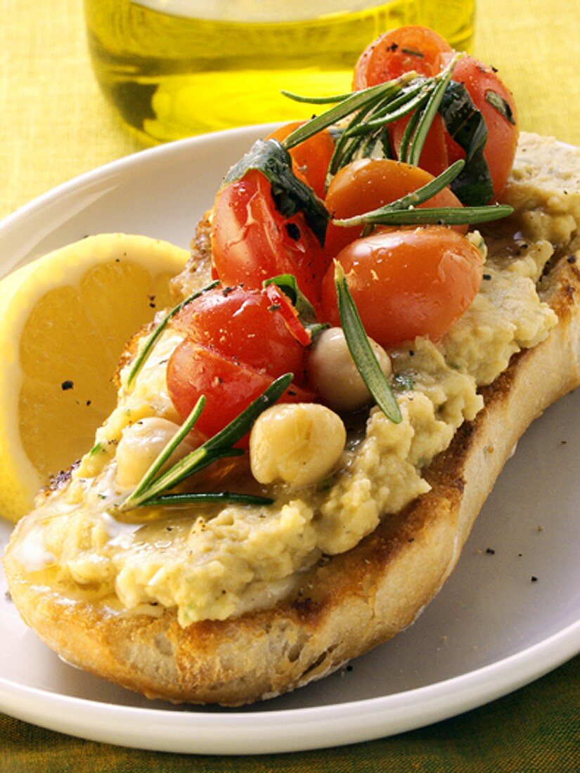 Sandwich with hummus, cherry tomatoes and rosemary