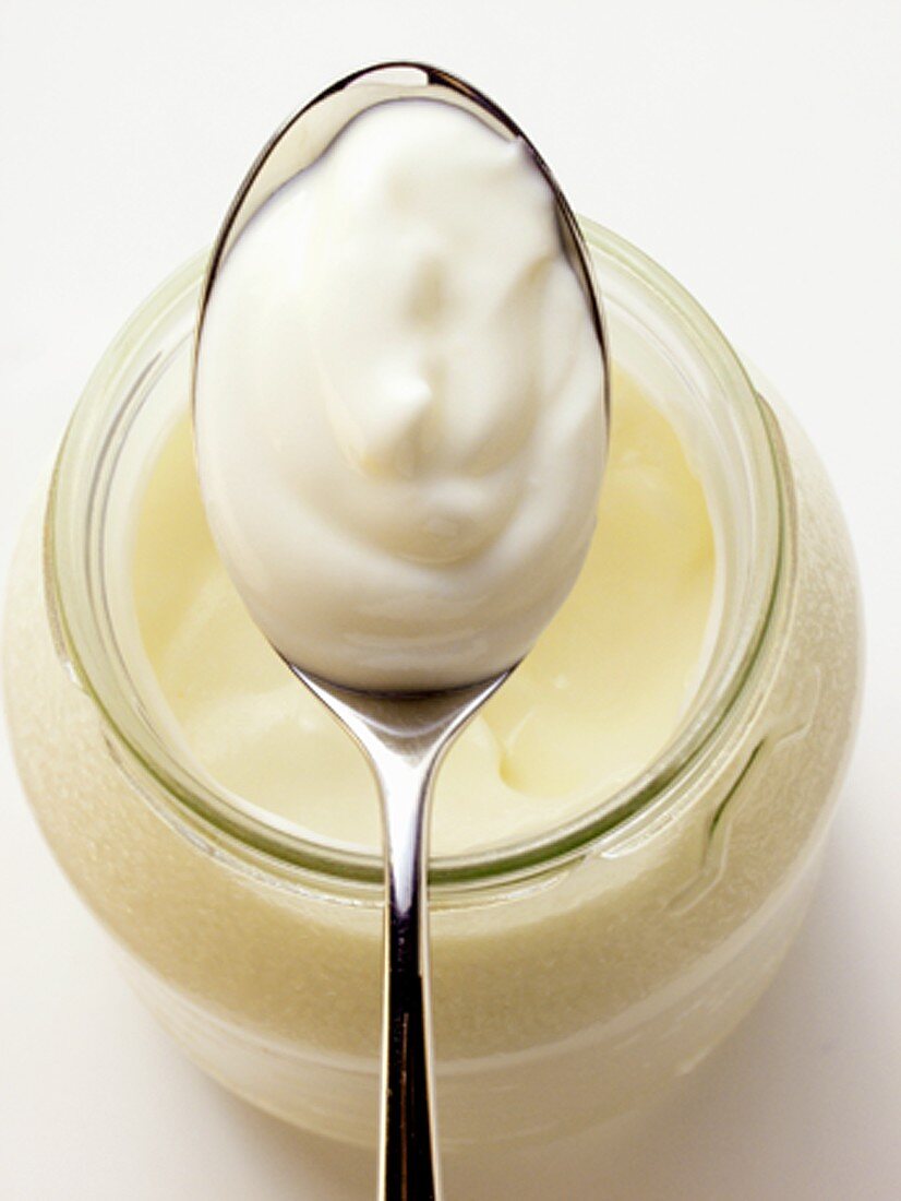 Yoghurt in jar and on spoon