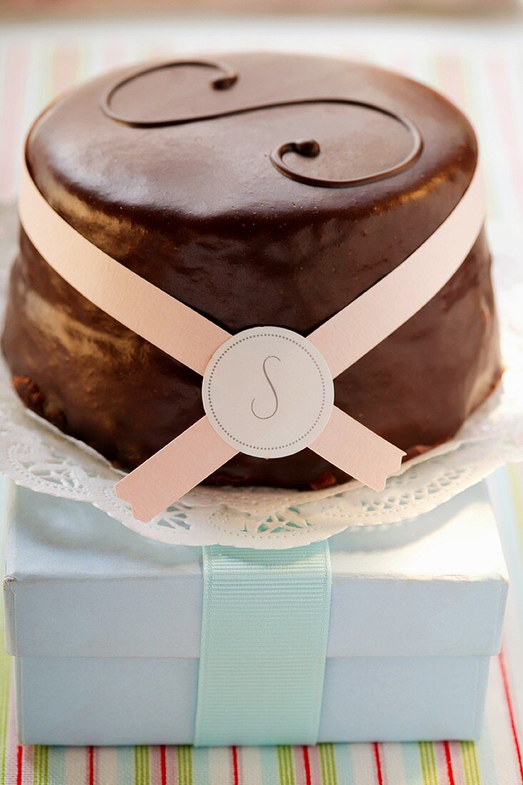 Sacher torte with paper bow on pale-blue box