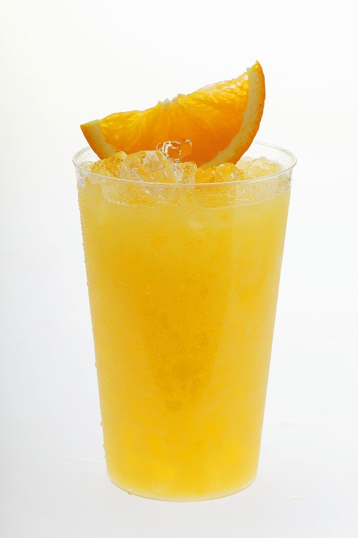 Orange juice with crushed ice and wedge of orange