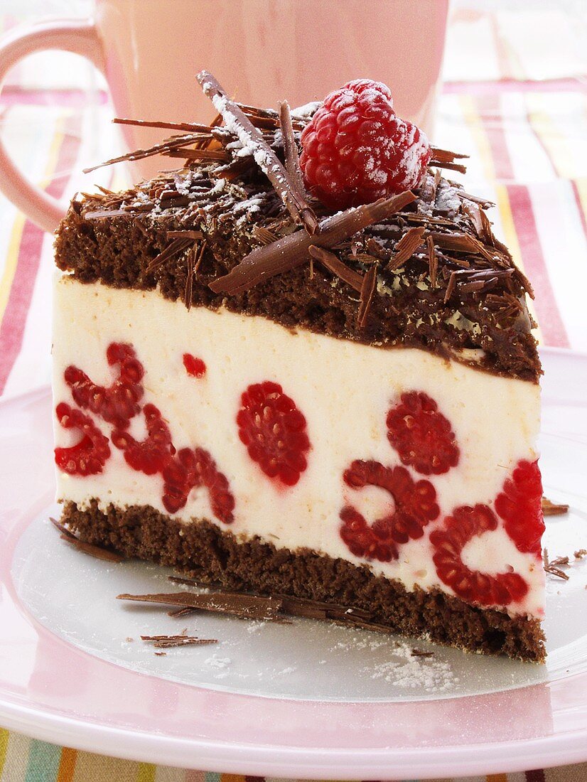 A piece of chocolate raspberry gateau with chocolate curls