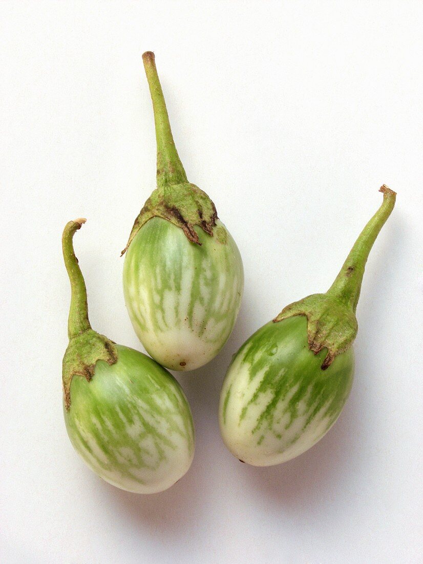 Three green and white aubergines