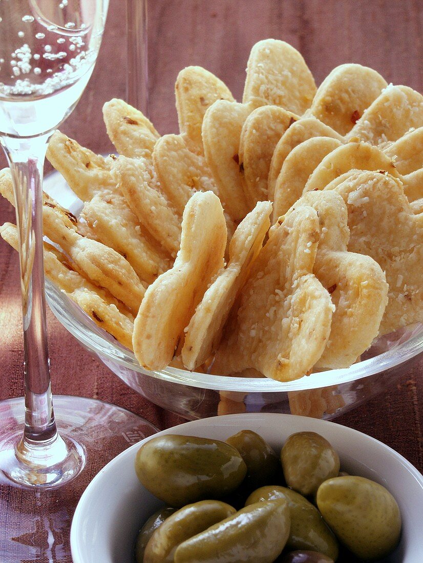 Parmesan hearts, green olives and champagne glass