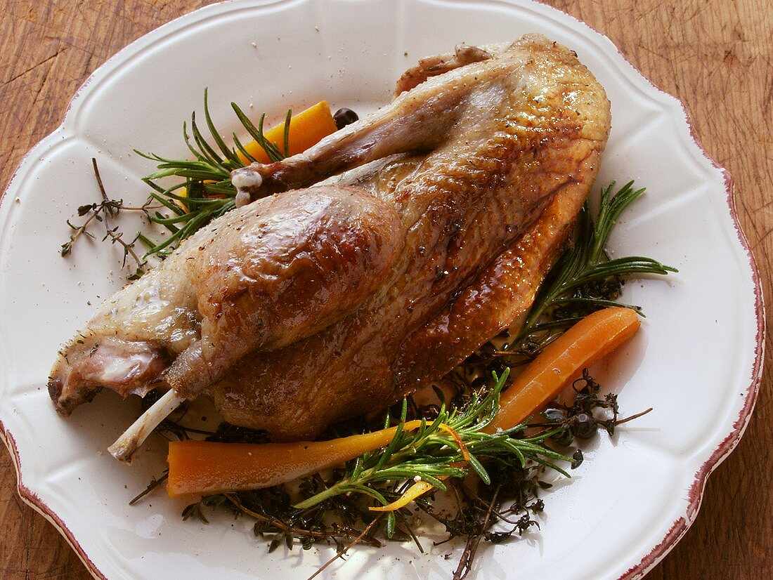Roast wild duck with herbs and carrots