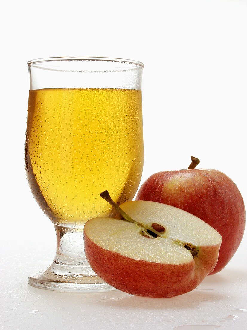 Glass of apple juice and fresh apples