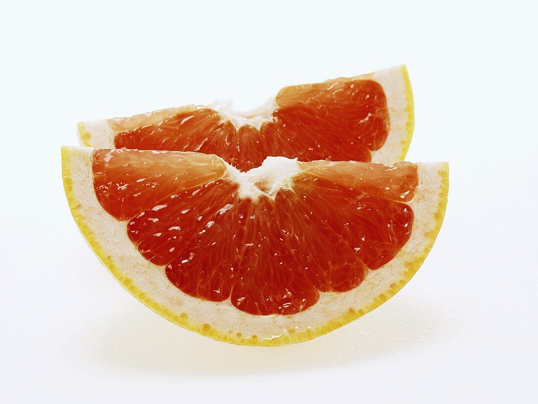 Two wedges of pink grapefruit