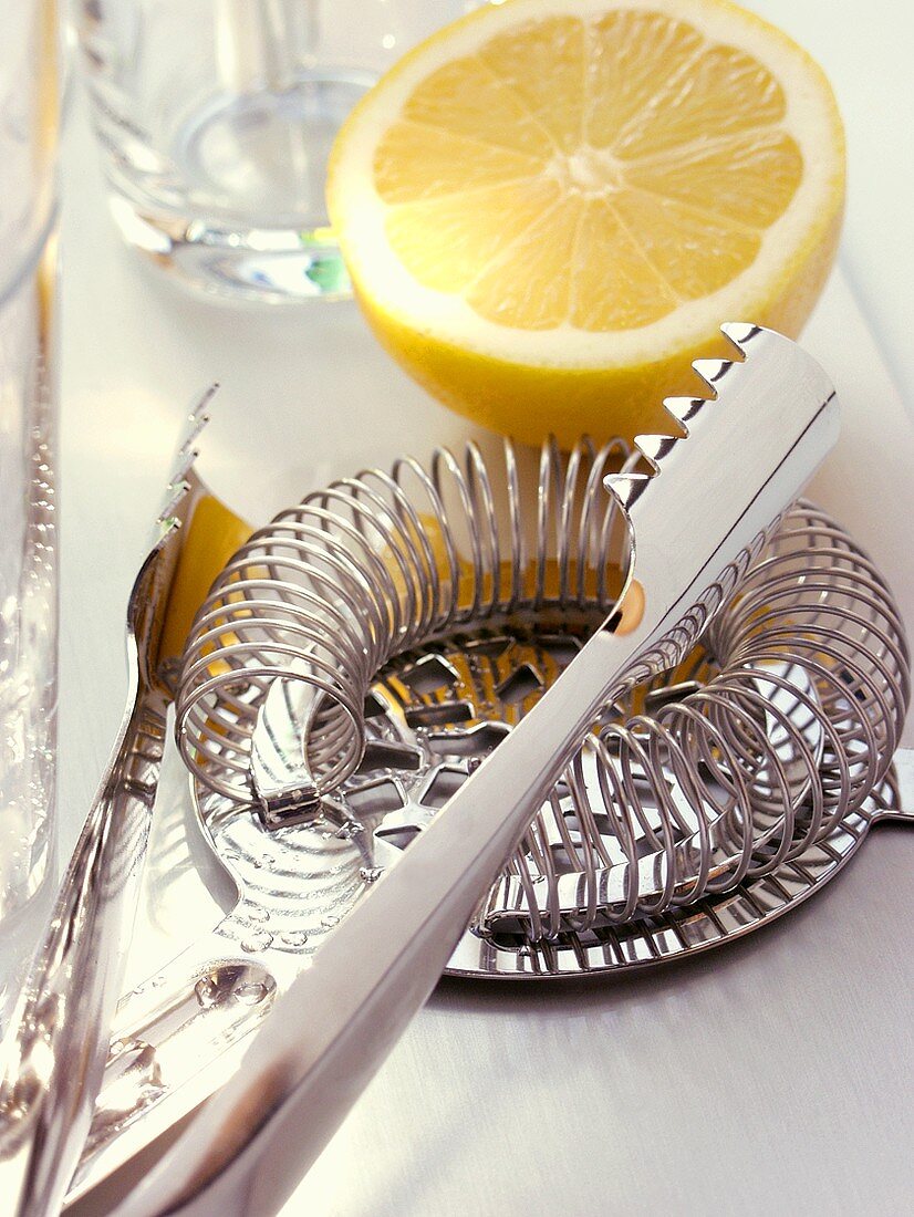 Various bar utensils and lemon