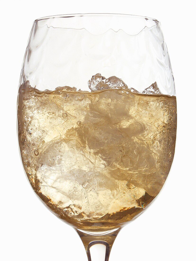 White wine glass with ice cubes