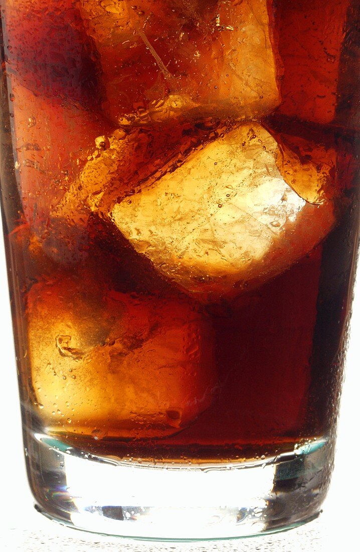 Cola with ice cubes in glass (detail)