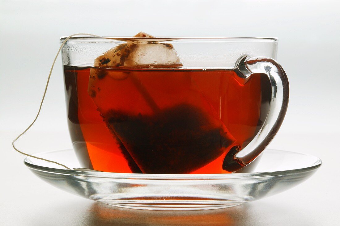 Hibiscus tea in glass cup with tea bag