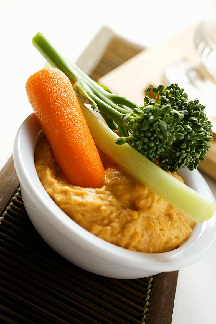 Carrot dip with vegetable sticks and broccoli