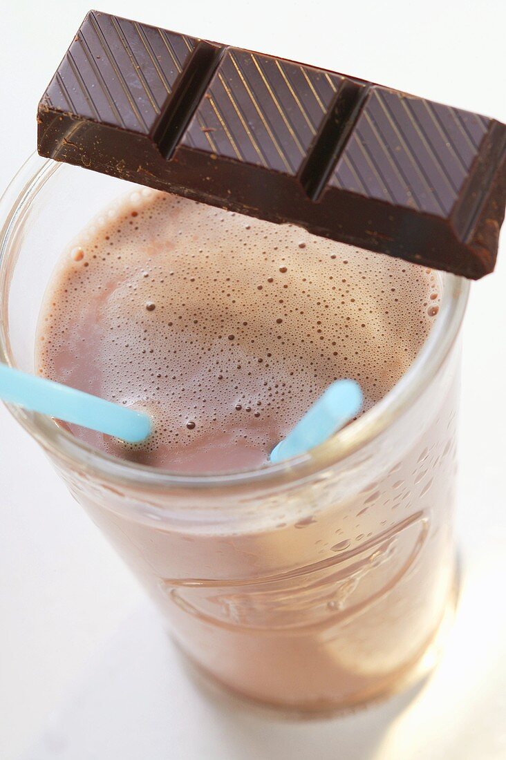 Cocoa in glass with piece of chocolate (from above)